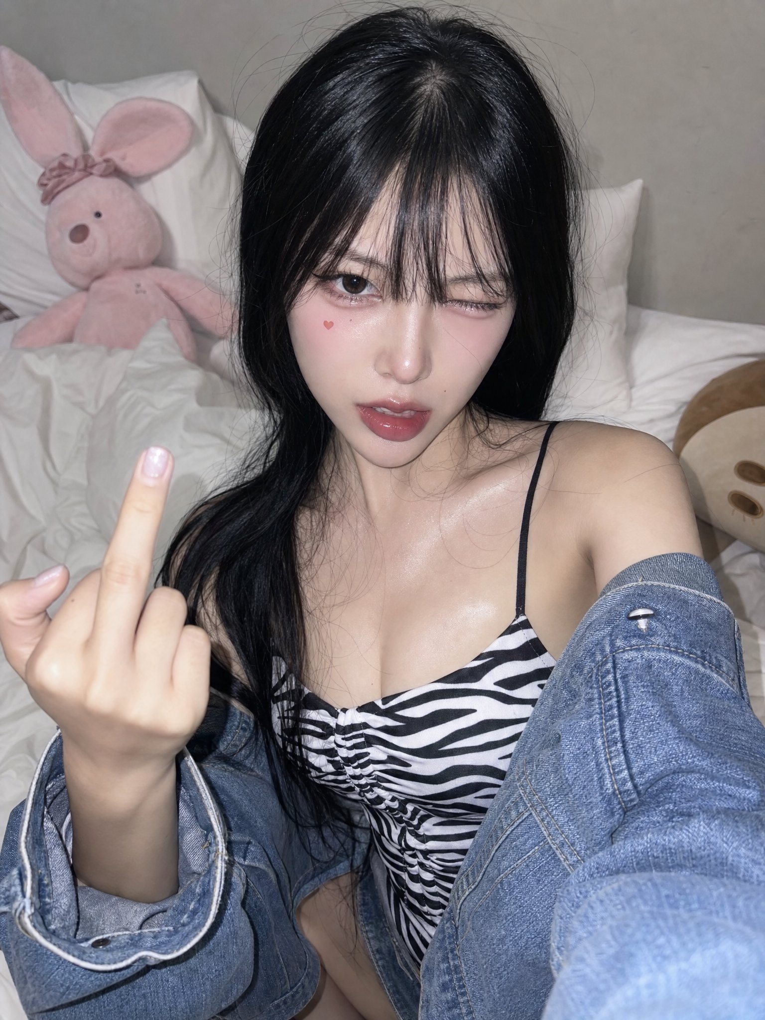 East asian phone-flash bedroom selfie