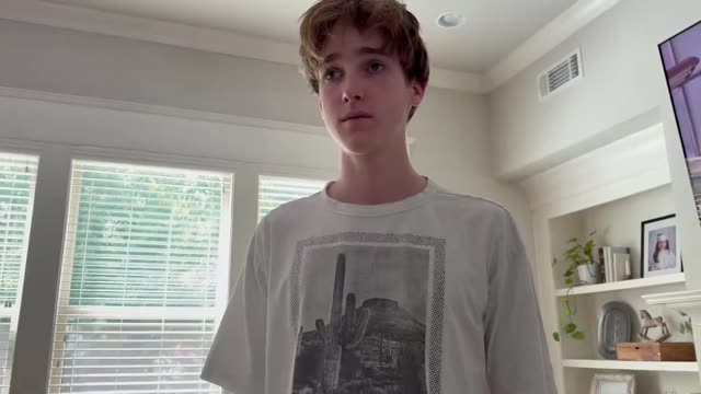 Young Man Walks and Speaks Indoors