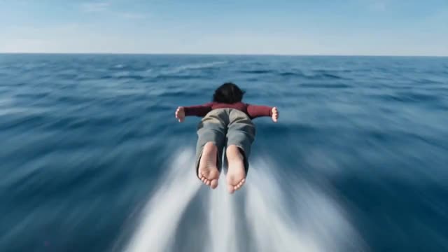 Woman Gliding Over Ocean