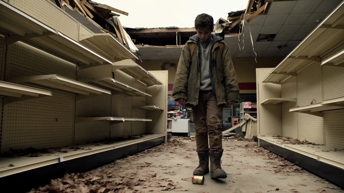 Teenage scavenger in an abandoned supermarket