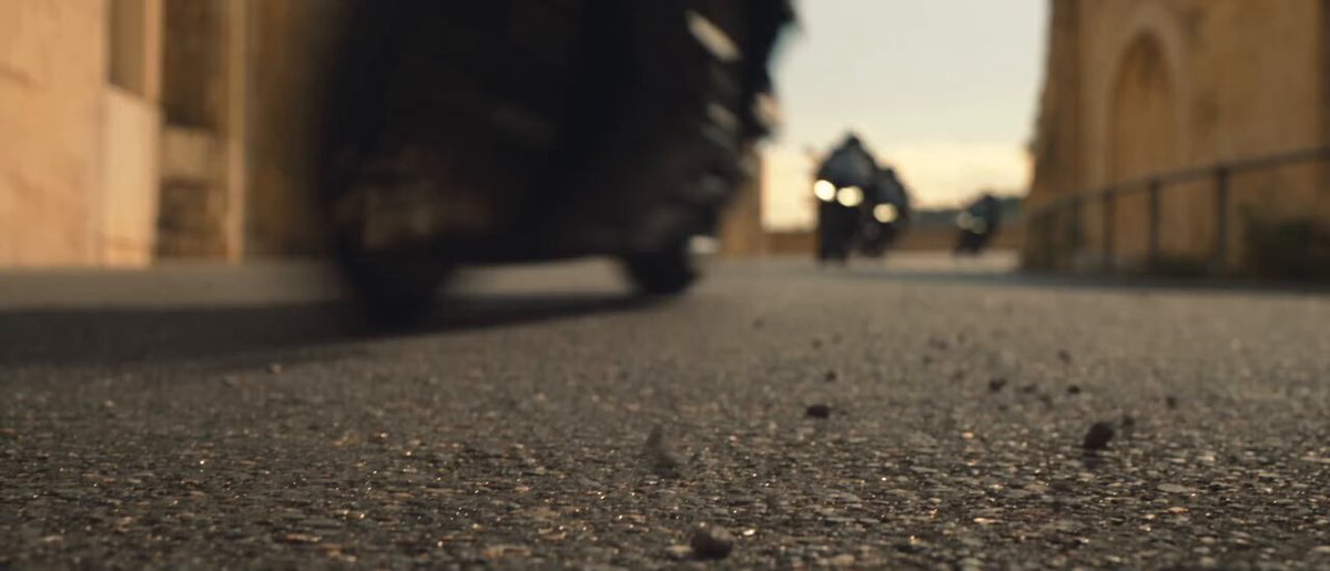 Young woman riding a superbike through a city