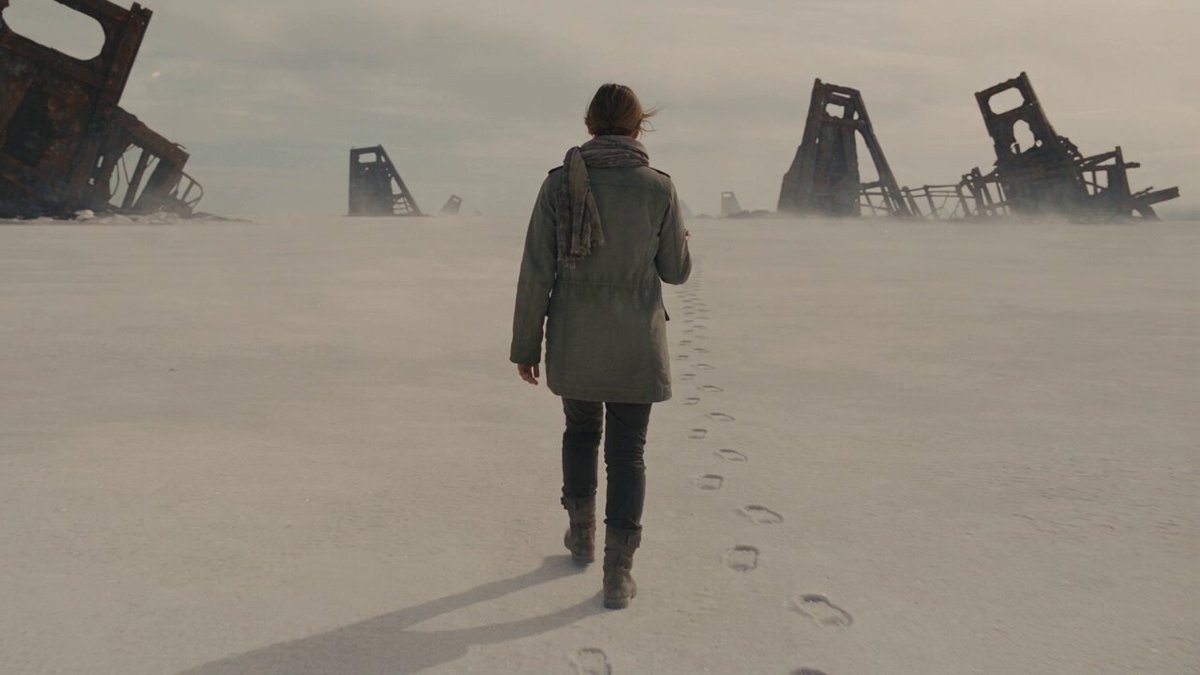 A woman walking across an abandoned salt plain