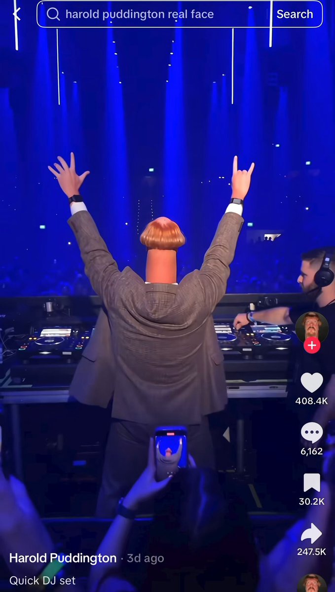 DJ in grey suit at sold-out show